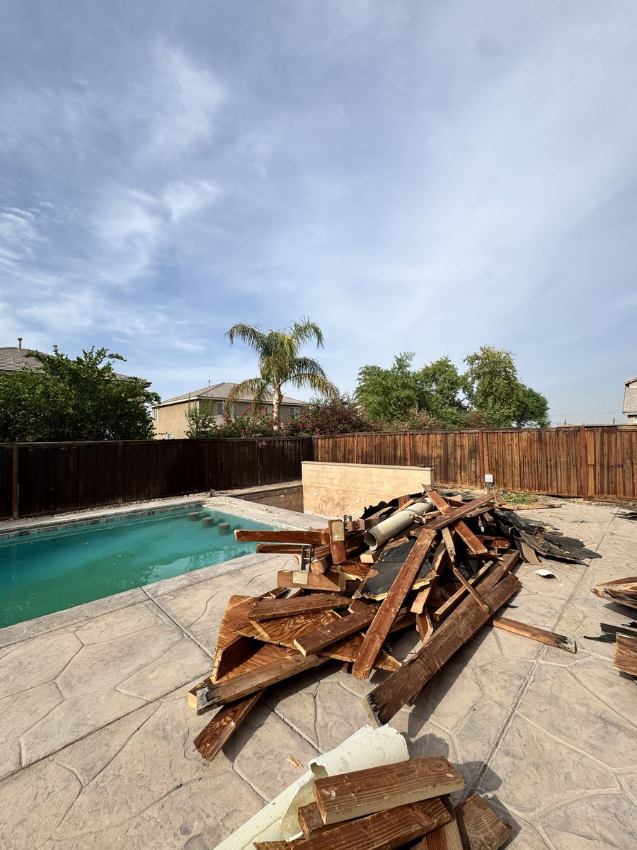 Patio structure torn down next to a pool