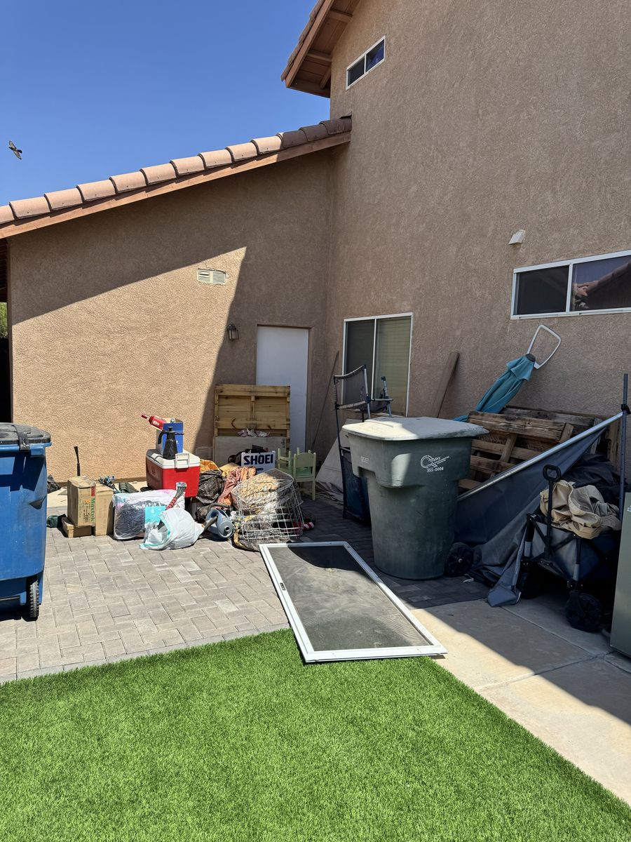 Side yard packed with household junk before removal